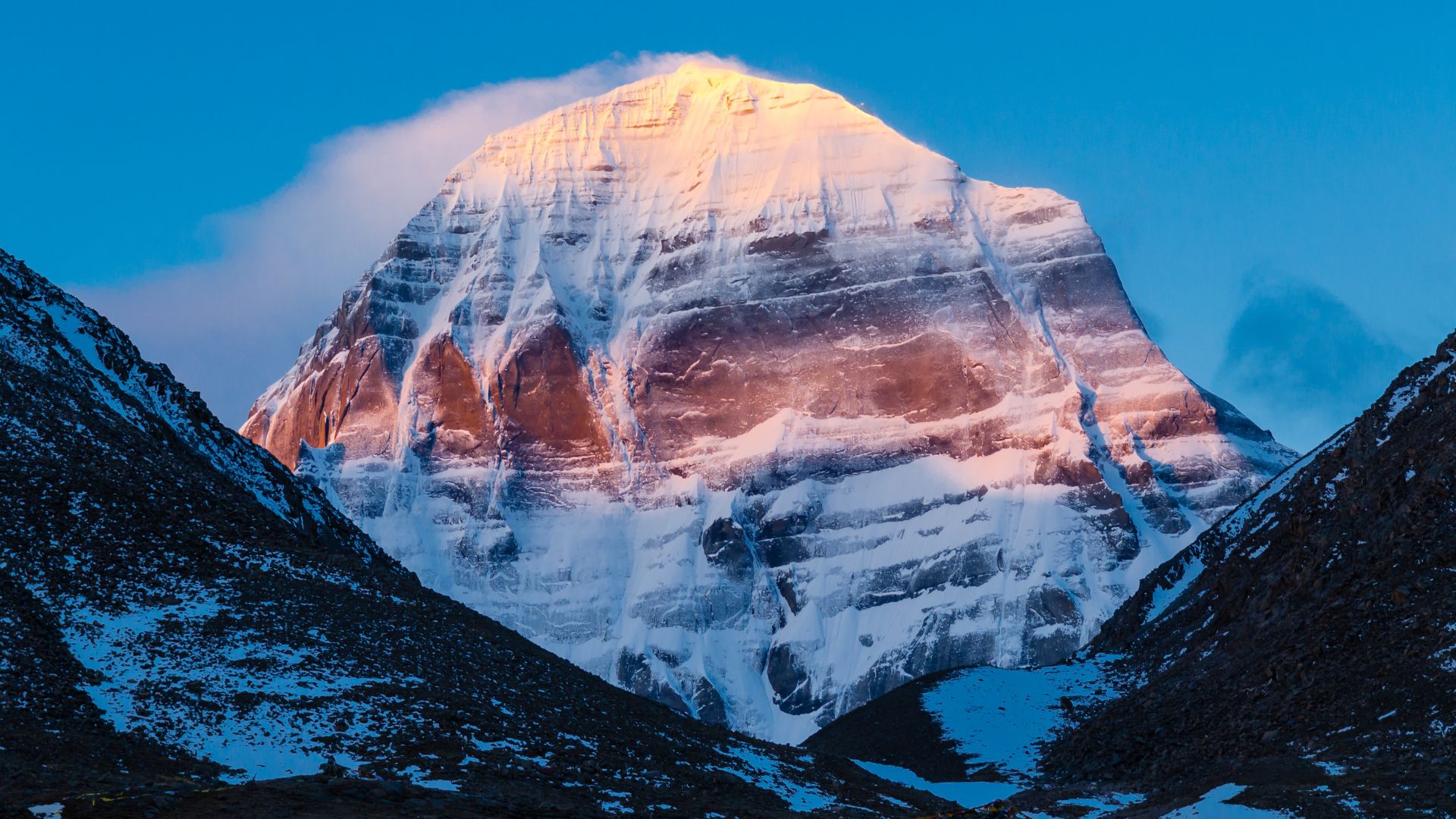 Mount Kailash reflected in Lake Mansarovar with prayer flags
