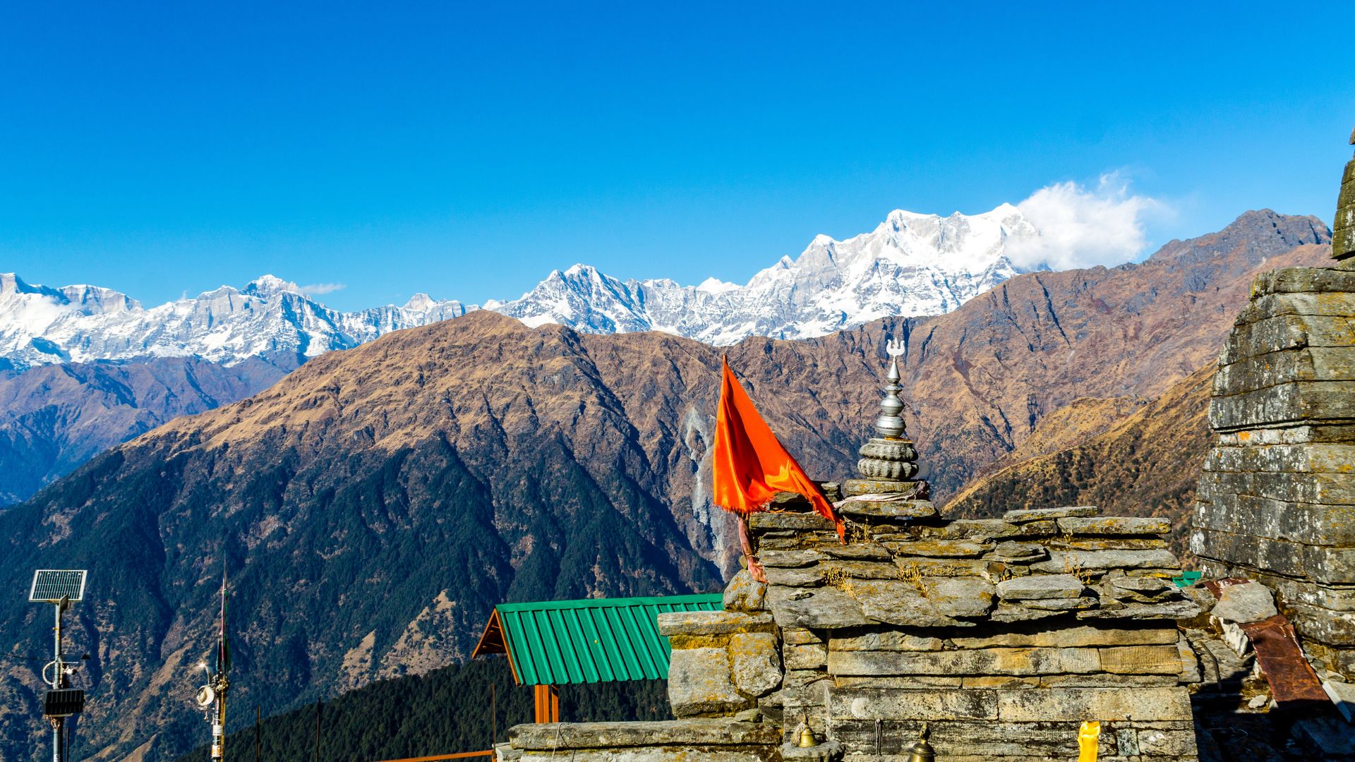 High Himalayan Shiva shrine surrounded by rhododendron blooms